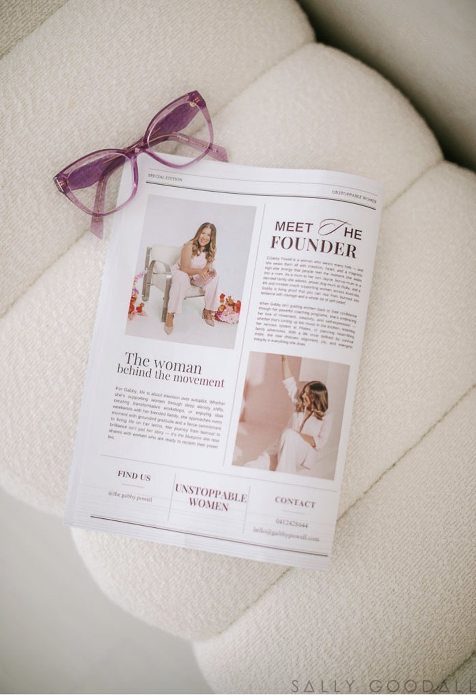 Purple glasses resting on a Meet the Founder newspaper feature about Gabby