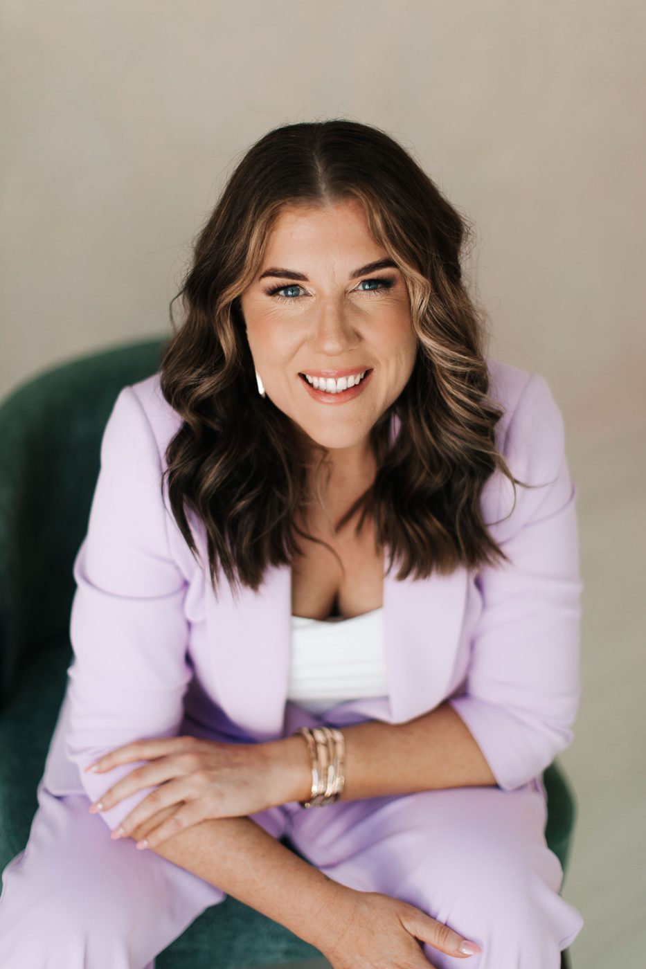 Gabby smiling warmly in a lilac suit